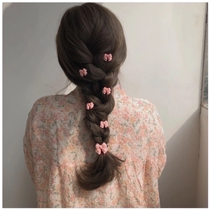 Pink bow hair clips set for women displayed on braided hair for a cute styling effect