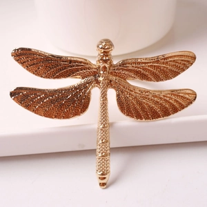 Elegant gold dragonfly cabinet handle and DIY jewelry box accessory on white background