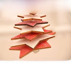 Detail of multi-layer wooden star pendant with red and white snowflake pattern texture