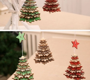 Close-up of red and green wooden Christmas tree ornaments hanging on branches