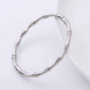 Sleek silver bamboo style stainless steel bangle shown from a 45-degree angle view
