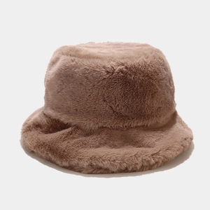 Close-up of thick faux rabbit fur fisherman hat showing soft plush texture and brown color