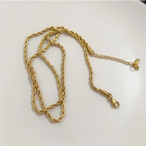 Detailed close-up of golden twisted rope chain with lobster clasp and extender
