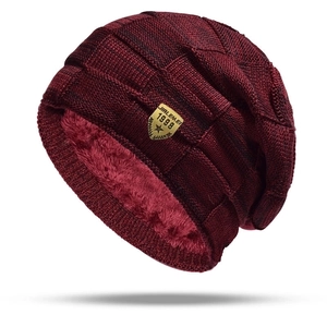 Winter knit beanie hat with thick fleece lining and shield logo in deep burgundy red