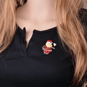 Festive Santa Claus brooch with Holiday Cheer engraving on a black textured sweater