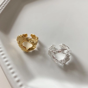 Detailed view of gold and silver irregular textured 925 sterling silver open rings