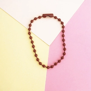 Macro view of reddish-brown ball chain link with secure clasp for DIY keychains