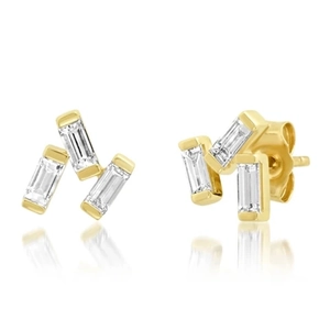 Detailed view of three-stone gold fish studs with marquise-cut zircons and reflections