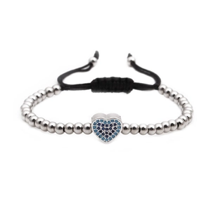 Woven bead bracelet with silver beads and a heart charm inlaid with blue zircons