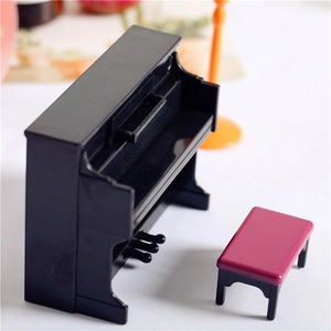 Close-up of miniature black upright piano and pink stool for dollhouse furniture set