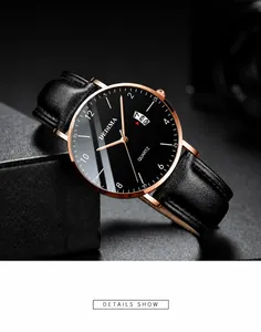 Detail of rose gold mens watch with black leather strap and calendar display