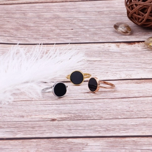 Minimalist 18k gold plated stainless steel rings with round black inlay on wood
