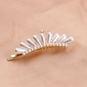 Elegant gold pearl crown hair clip with rhinestones for women on pink silk background
