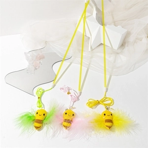 Detailed view of three cat teaser wands featuring bee charms and soft colored feathers