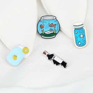 Set of 4 cute enamel pins featuring fish tank, starry bottle, lemon jar and wine bottle