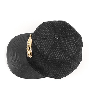 Detail of hip hop hat with golden crown logo and black honeycomb mesh texture