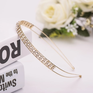 Detail of elegant gold double-row headband with sparkling rhinestones on vintage book