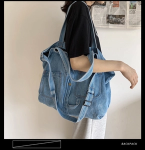 Detail showing vintage denim tote bag with adjustable shoulder strap and large pockets
