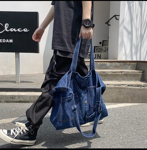 Detailed view of large vintage denim tote bag with patchwork and metal buttons