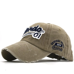 Close-up of vintage washed khaki cotton cap with Orlando 01 towel embroidery detail