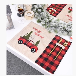 Linen Christmas placemat with red truck print and cutlery pocket for holiday dining decor