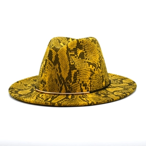 Detailed macro view of yellow snakeskin pattern wool fedora with gold metal trim