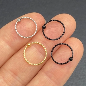 Detail showing various colors of surgical steel captive bead rings for nose and ear piercing