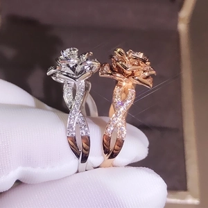 Exquisite 18K rose gold and silver flower rings with zircon accents on velvet