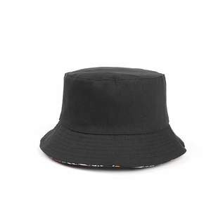 Detail of classic black bucket hat featuring a colorful bohemian print on the inner brim