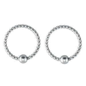 Close-up of silver twisted stainless steel nose rings with captive bead texture