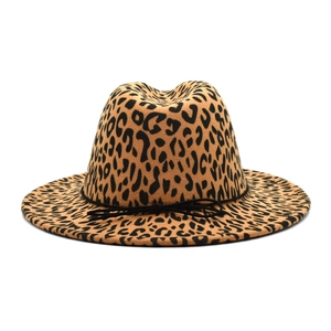 Detailed close-up of leopard print wool fedora hat with elegant black bow ribbon tie
