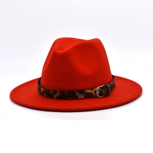 Detailed macro view of red wool fedora hat featuring a stylish leopard print belt with buckle