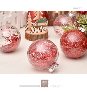 Macro detail of transparent Christmas ball ornaments with red festive fillings and pine cones