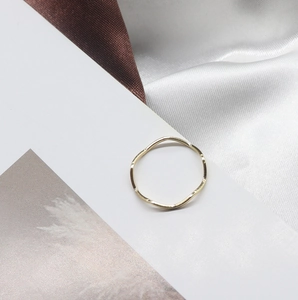 Irregular wavy gold ring with adjustable open band on elegant silk background