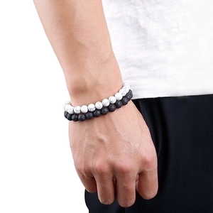 Men's natural lava stone and white marble beaded bracelet set on white background