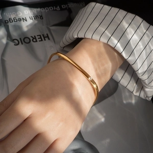 Minimalist square titanium steel gold bracelet with zircon inlay on female wrist