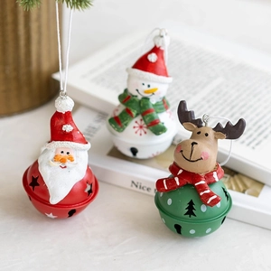 Christmas iron bells with Santa, Snowman and Reindeer ornaments on pine branch background