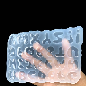 Macro shot of flexible transparent silicone alphabet mold for DIY resin jewelry making