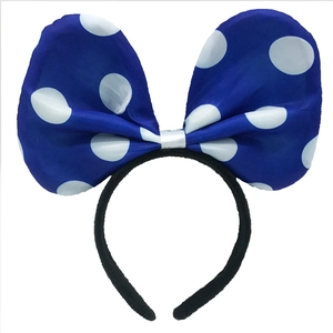 Detail of blue polka dot bow headband featuring high-quality fabric and classic white spots