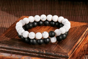 Detailed view of 8mm matte black and white marble stone beads on elastic bracelets