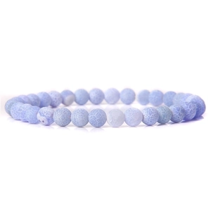 Macro detail of 6mm light blue natural stone beads with unique dragon vein patterns