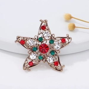 Christmas star brooch with red and green crystals on a vintage gold alloy base