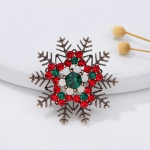 Festive snowflake brooch with red and green rhinestones on a vintage gold metal base