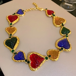 Detail of vintage necklace with multi-colored glass heart links and gold settings