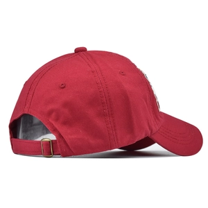 Detail view of cotton baseball cap featuring adjustable metal buckle and embroidery