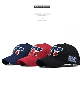 Detailed view of three vintage cotton baseball caps with large embroidery in a flat lay