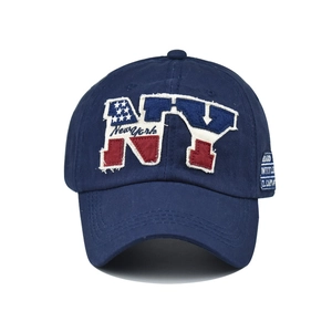 Detail of NY patch embroidery and New York stitching on navy cotton baseball cap