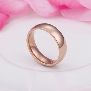 Minimalist rose gold titanium steel ring with polished finish on a white ceramic plate