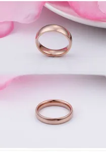 Detailed view of polished rose gold titanium steel ring with mirror finish on white