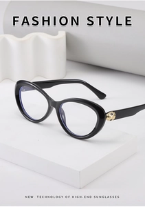 Detail of elegant gold leopard head metal emblem on glossy black cat-eye sunglasses